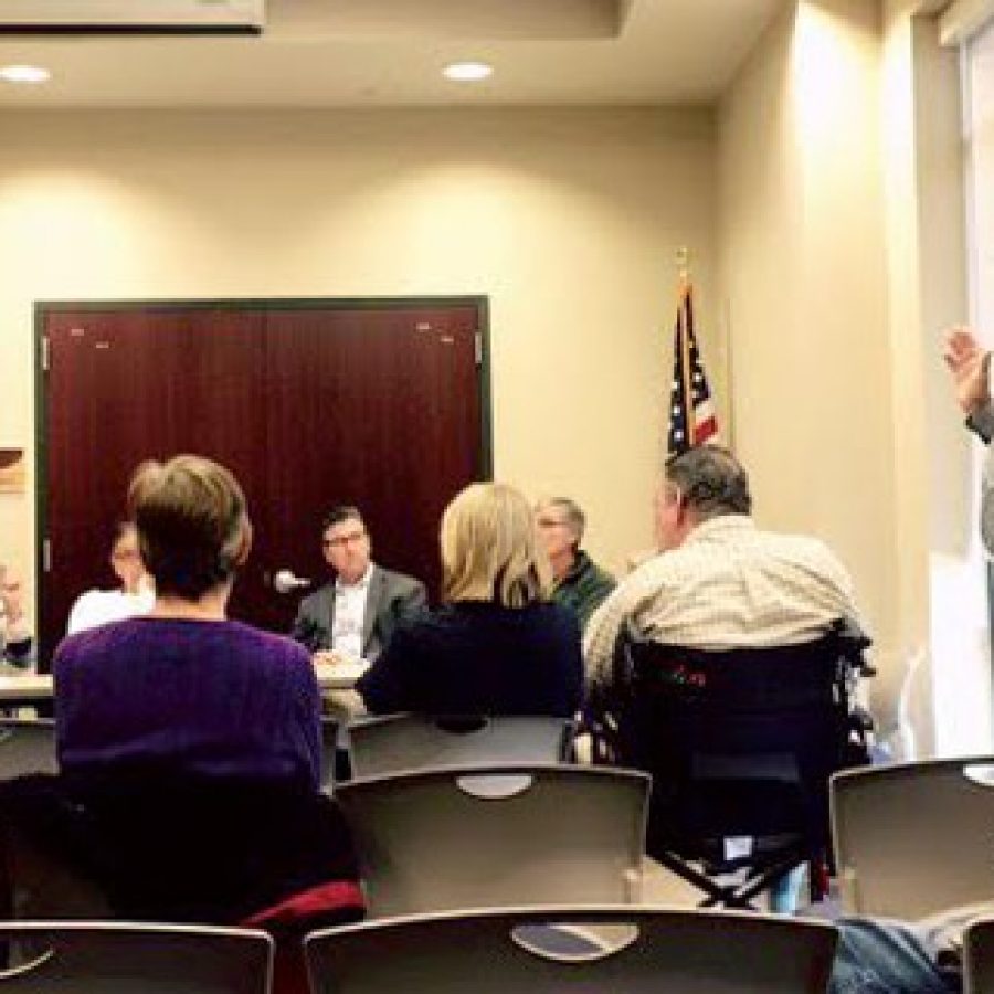 Mayor Mark Furrer, right, exchanges words Saturday morning with Court Drive resident Ann McMunn, second from left.