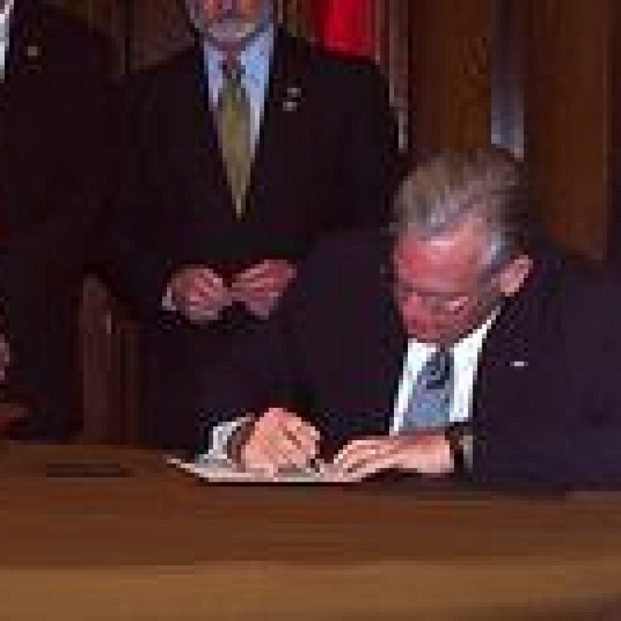 Gov. Jay Nixon signs a bill Wednesday altering dog-breeding restrictions. 
