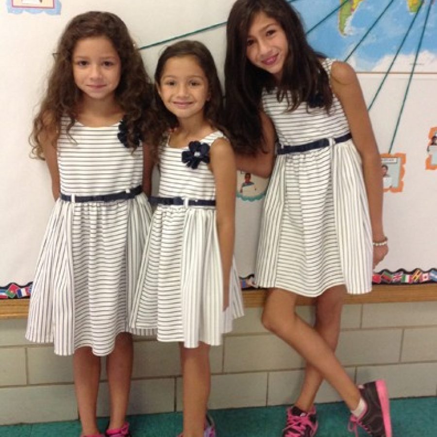 Sisters  from left, Isabella, Sabrina and Sandra Halilovic donned matching dresses Sept. 30 for picture day at Crestwood Elementary School. Lindberghs districtwide picture day is also Be There Day, or the official enrollment date for the 2015-2016 school year. This year the district saw an increase of 200 new students in grades K-12. The sisters are in grades three, kindergarten and four, respectively.