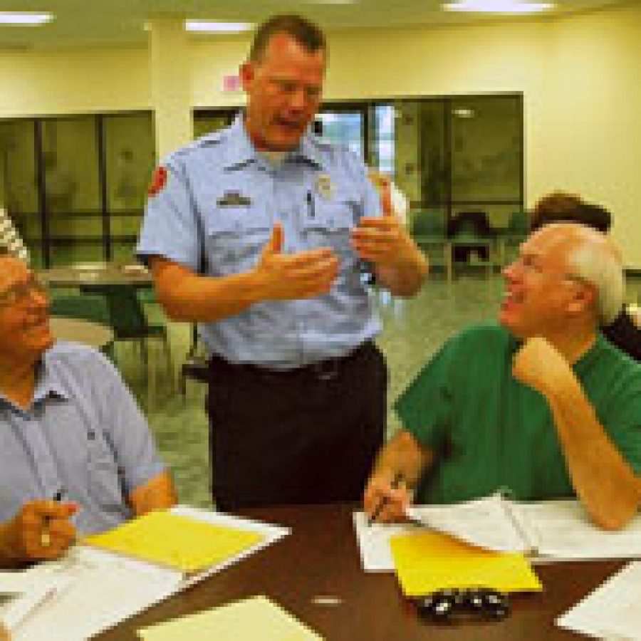 Mehlville Fire Protection District Paramedic Doug Weck, standing, discusses staffing options with Albert Fuchs, left, and Gary Gross during the June 30 meeting of the districts Fire District Advisory Committee for Tomorrows Emergency Services, or FACTS.
Bill Milligan photo
 
