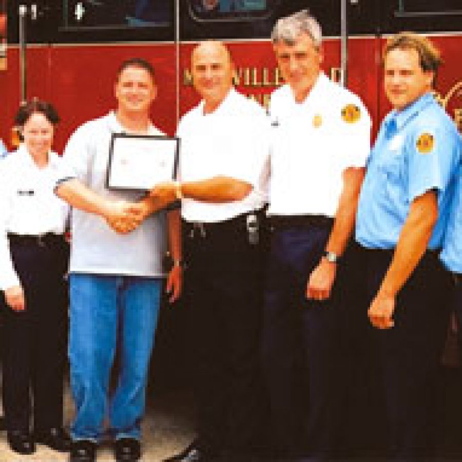 Mehlville Fire Protection District resident Kevin Driskell is honored by the fire district for his selfless and heroic efforts to evacuate residents during a fire at his condominium complex. Pictured, from left, are: Pvt. Mitch Fassler, Lt. Joanne Evans, Driskell, Deputy Chief Steve Mossotti, Capt. Nick Fahs, Pvt. Craig Dexter and Pvt. Doug Weck.