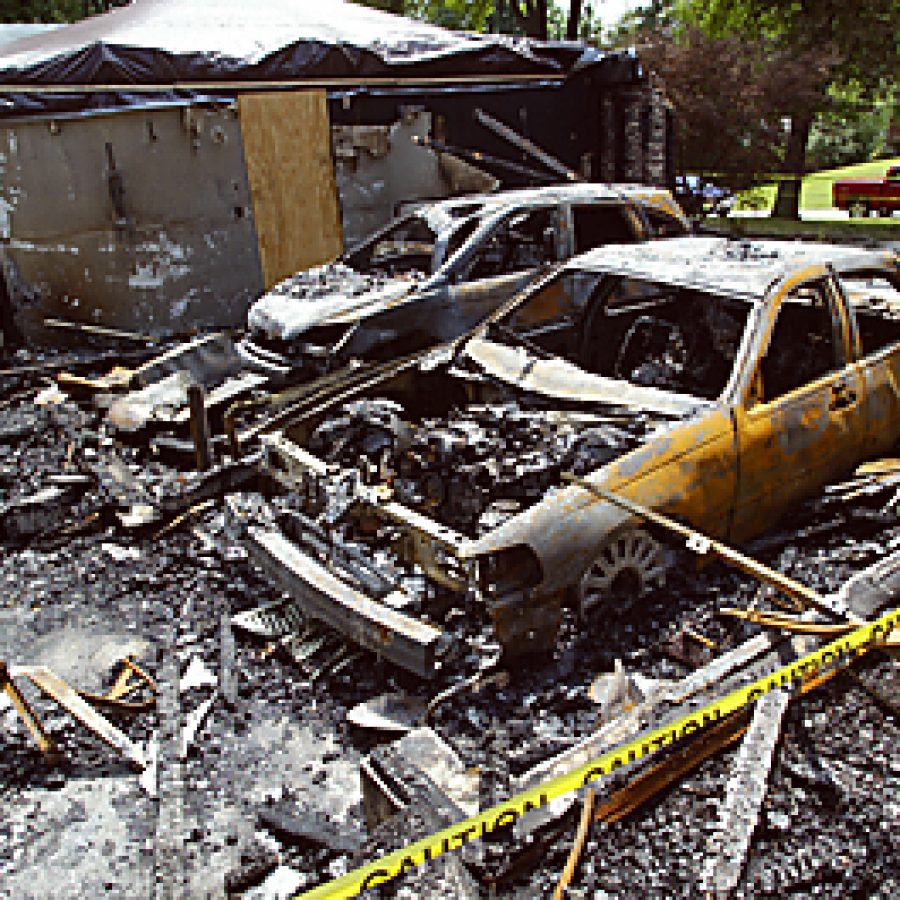 Two automobiles parked in the garage at the home of Raymond and Patricia Vien in the 1000 block of Druso in Mehlville were damaged by a fire Sunday morning. A third, parked nearby in the driveway, also was damaged. On Monday, homeowners were still trying to assess the damage during meetings with insurance agents and smoke-abatement professionals. Bill Milligan photo