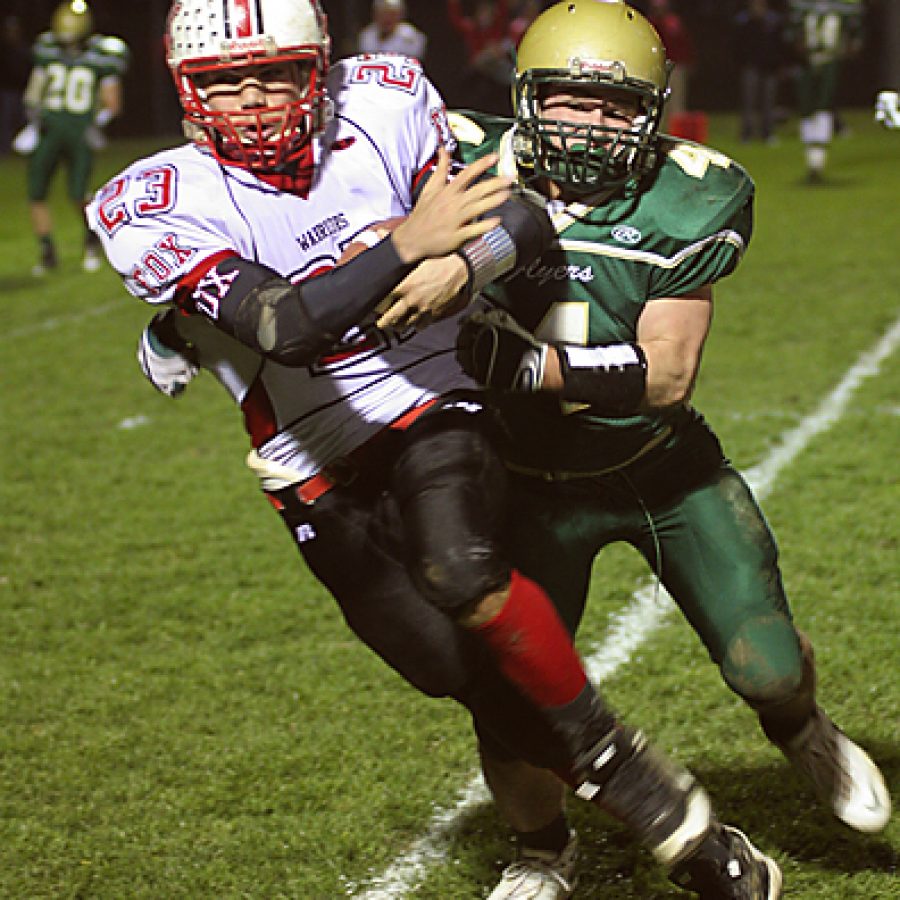 Fox running back Jimmy Brewer cuts to the outside with Lindbergh linebacker Eric Schwartz in pursuit during the Warriors 31-28 win Friday night. Stephen Glover photo