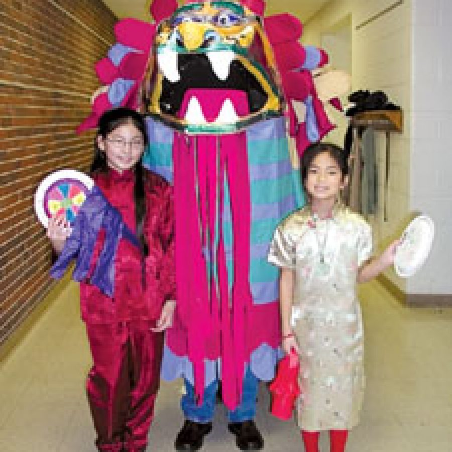 Blades Elementary School pupils recently celebrated the Chinese New Year. The observance of the Chinese New Year has become an annual event at Blades as Oakville Senior High teacher Gail Wood visits Blades each year to educate pupils about the Chinese culture. Above, Abigail and Millicent Wood prepare to lead the Dragon Parade.  
