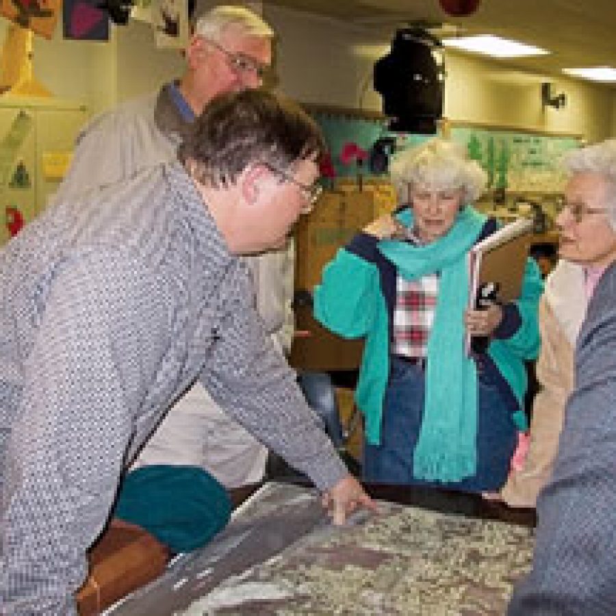 Gerry Biedenstein, left, of the St. Louis County Parks and Recreation Department points to a map as he discusses with residents the proposal to donate nearly 300 acres of Mississippi riverfront property for a county park.Alyson E. Raletz photo 