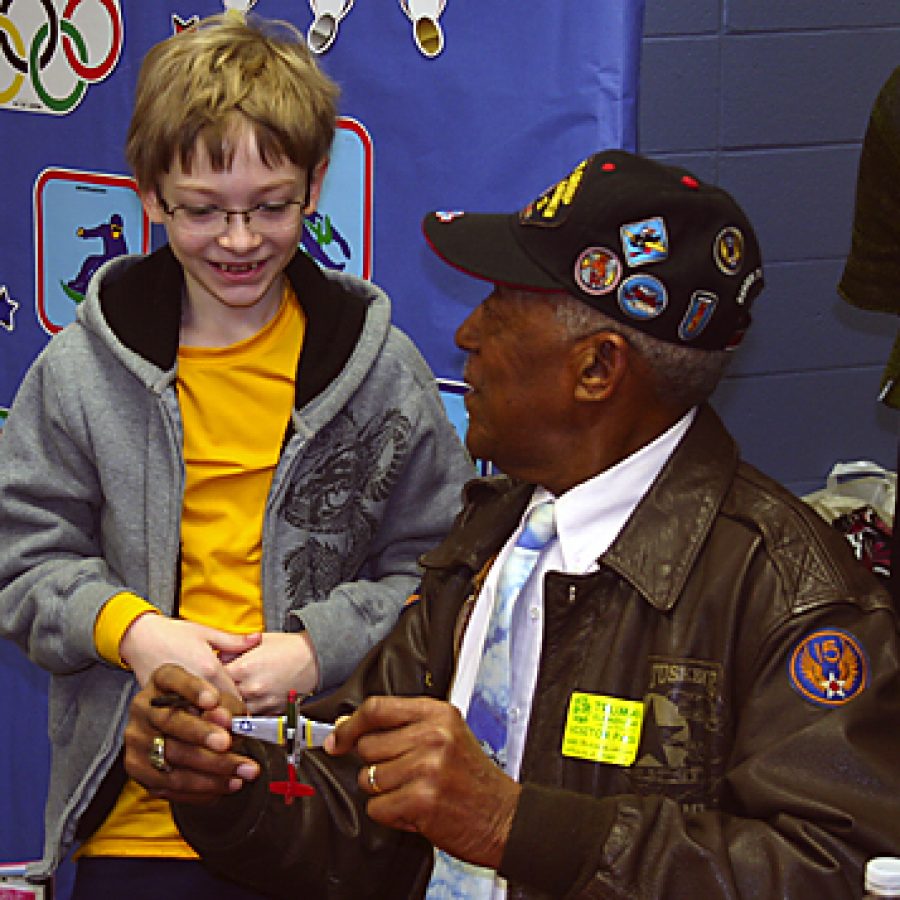 George Watson Sr. autographs a model airplane for Truman Elementary fifth-grader Alex Nejelski.