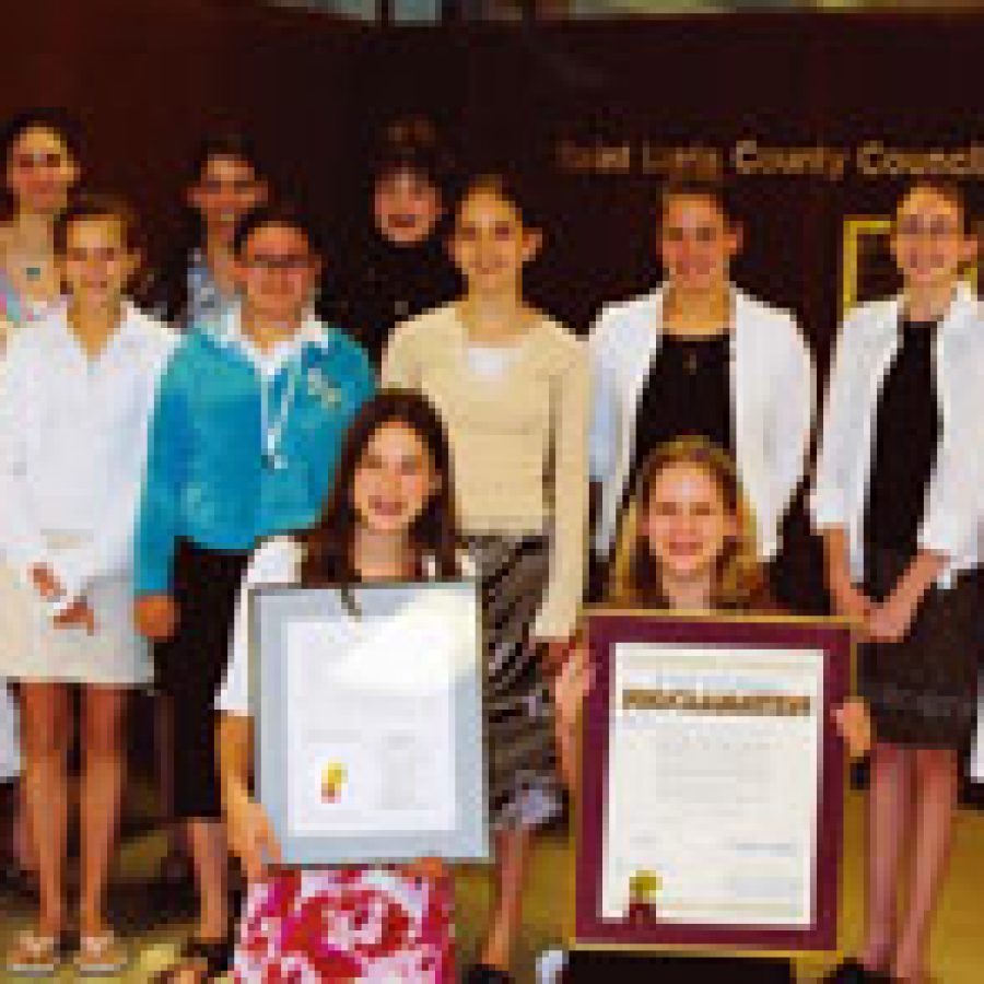 Girl Scouts from the St. Catherine Laboure Parish who received their Marian Award medals are shown with a proclamation and resolution they received from St. Louis County officials. Pictured, front row, from left, are: Jillian Hoge and Carri Banholzer. Middle row, from left, are: Melissa Stumpf, Kelsey Stroble, Theresa Helm, Lauren Fitch, Courtney McArthur, Kim Klipsch and Patricia Ruzicka. Back row, from left, are: Rachal Yanker, Mary Stephens and Molly Baumgartner. Not pictured are: Desiree Cain, Lindsey Geier, Danielle Grasso, Margie Laurentius, Amanda Pfeil and Elizabeth Wiele.