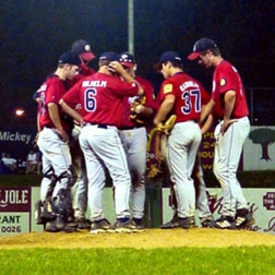 Head coach Mike Wilhelm calls his troops to the mound during the eighth inning of Oakvilles 7-6 win over Lemay Sunday evening.
Stephen Glover photo 