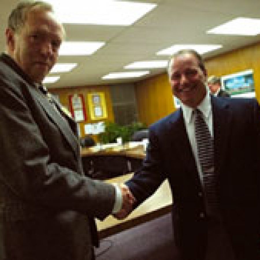 Outgoing Mehlville Board of Education Rich Huddleston, left, shakes hands with newly elected member Tom Correnti, who took the oath of office last week. The April 13 meeting was Huddlestons last after serving six years on the board.
Bill Milligan photo
 