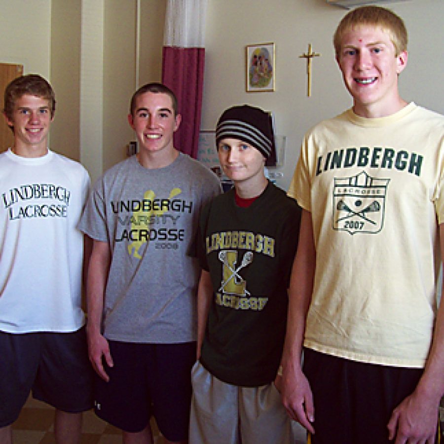 Lindbergh Lacrosse players Andy Thurby, D.J. Ullrich, Jake Franzel and Steve Kaiser catch up in Jakes room at Cardinal Glennon. Jakes teammates raised \$1,250 in his honor last spring, which has been donated to Friends of Kids With Cancer and the Make-a-Wish Foundation.