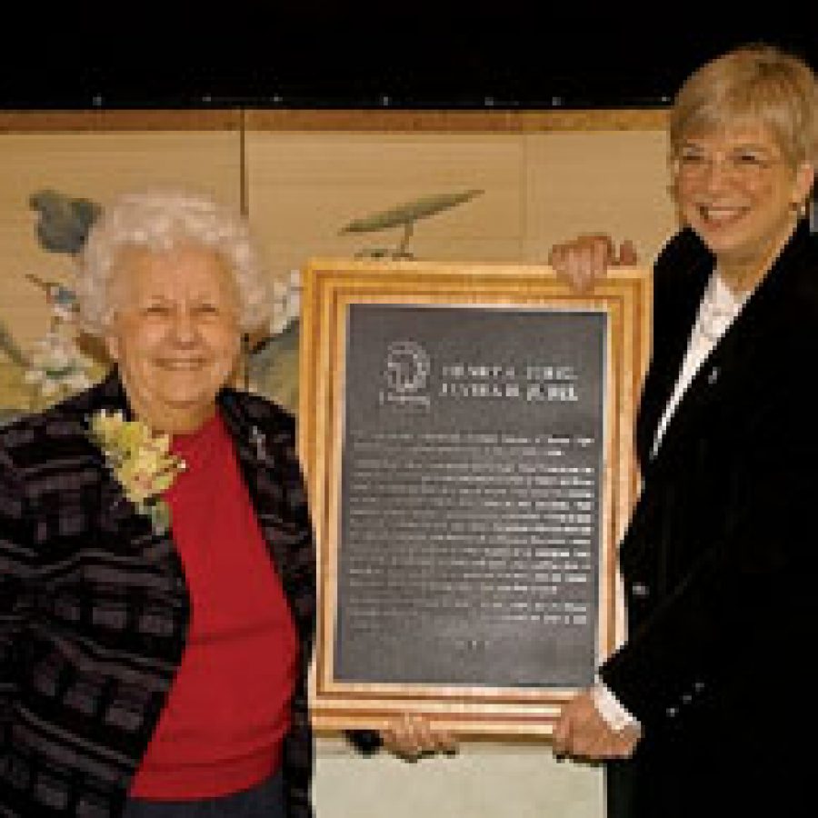 Elvira Jubel, left, accepts a plaque from Judith Meyer, president of the Lutheran High School Association, in recognition of the Jubel familys gift to the capital fund of the Lutheran High School Association.