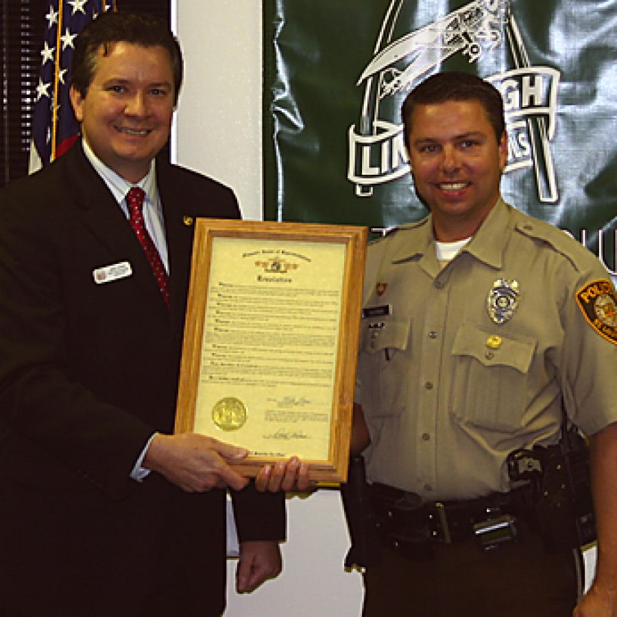 Rep. Mike Leara of Concord, left, presents Sperreng Middle School Resource Officer Mike Kaufman with a resolution last week recognizing Kaufmans commitment and concern for pupils and the community. Kaufman was honored this summer as the 2009 Missouri School Resource Officer of the Year.