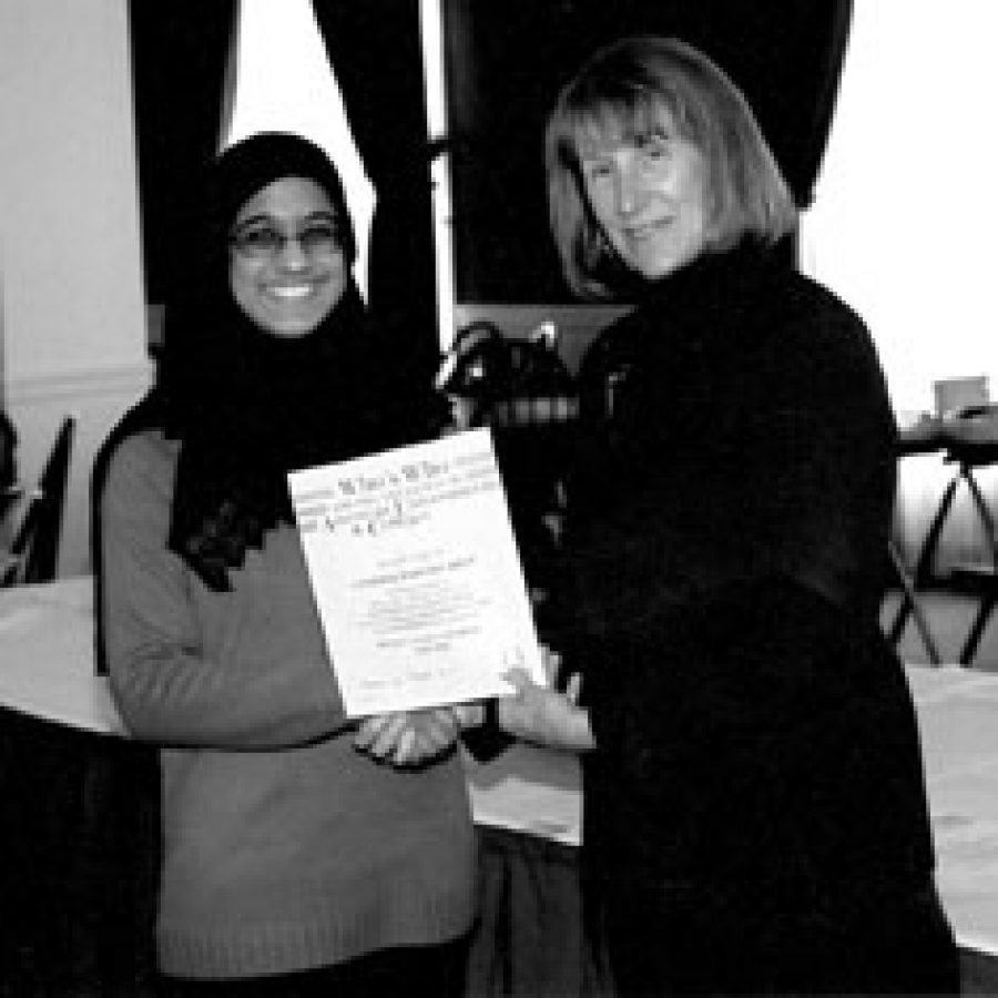 Cynthia Khan, left, a Truman University student who has been named to the 2003-2004 edition of Whos Who Among Students in American Colleges and Universities, is shown with Truman State President Barbara Dixon.