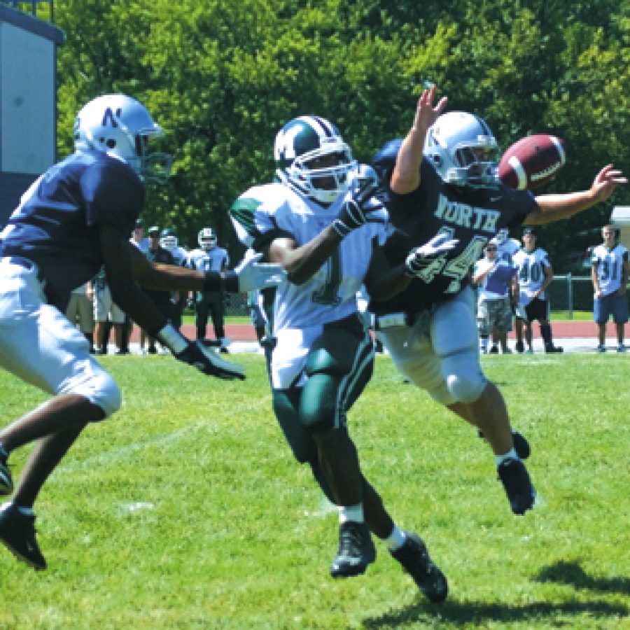 Mehlvilles Rashad Wilson, center  has the ball swatted from his waiting arms by McCluer North linebacker Caleb Yarbrough in the first quarter of Saturdays game.