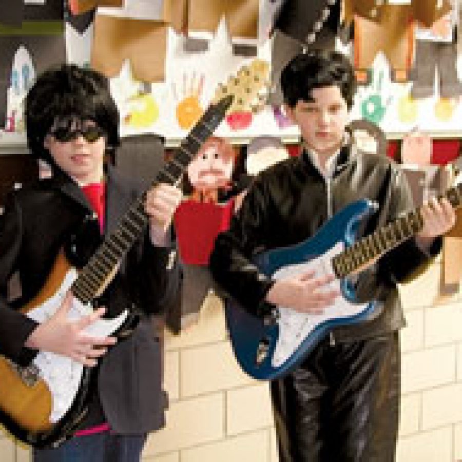 John Lennon, portrayed by Adam Roderique, and Elvis Presley, portrayed by Ella Gould, get ready to play their guitars during Oakville Elementarys Living Museum.