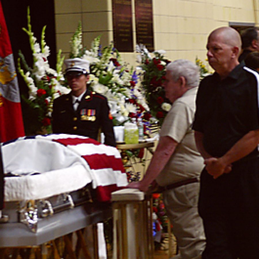 John Diethelm and Bob Keeling pay their respects to Cpl. Donald Marler during a visitation Monday afternoon at Oakville Senior High School. Cpl. Marler, a 2006 Oakville graduate, was one of three Marines killed in a single-vehicle crash June 6 during combat operations in Afghanistan. Bill Milligan photo