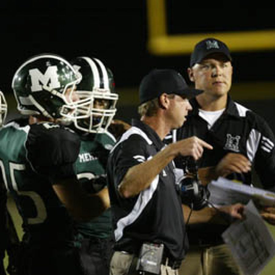 Mehlville Senior High School head football coach Eric Meyer, pointing, goes over some strategy with his players early in Fridays outing against Parkway South. The Panthers prevailed 30-10 over Parkway South for their third consecutive victory.