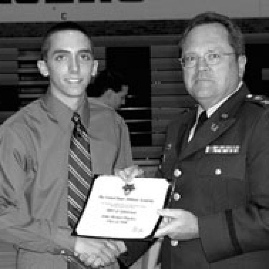 Col. Jack Olson, right, U. S. Army Reserve Military Academy liaison officer, presents John Michael Hughes with the West Point Military Academy Scholarship. Hughes also won the Outstanding Performance Social Studies Departmental Award, the George Washington Carver Award and the Outstanding Academic Achievement Certificate.