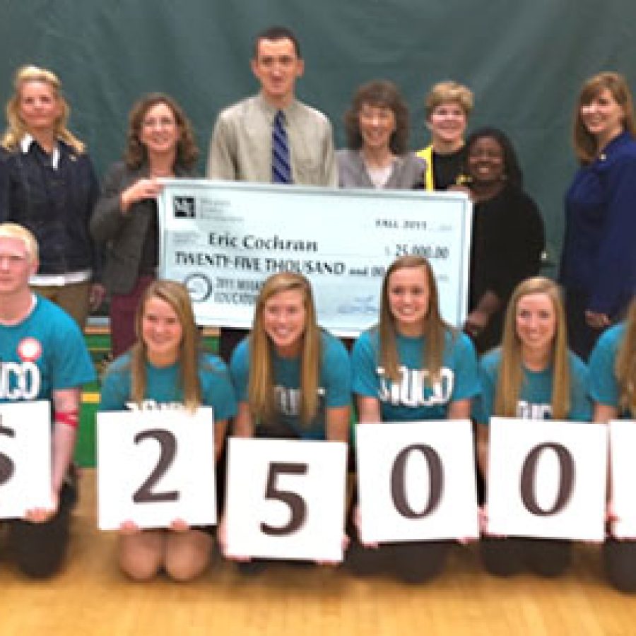 Eric Cochran, center, a social studies teacher at Lindbergh High School, was surprised at an all-school assembly Wednesday with a Milken Family Foundation National Educator Award — and an unrestricted cash price of \$25,000. 