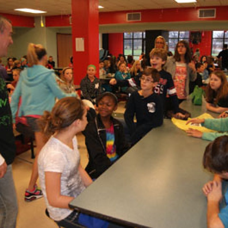 Oakville Middle School Principal Mike Salsman, left, talks to OMS students during the schools Peace, Love and Pizza-themed Mix It Up Day.