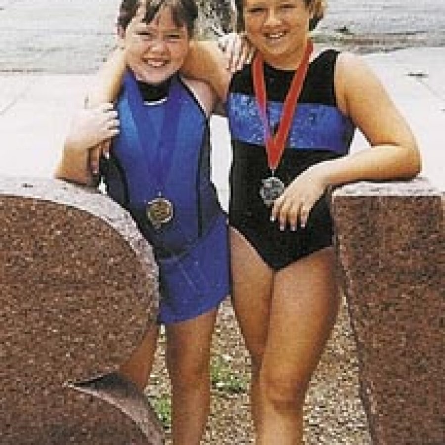 Becky Watters, left, and Jessica Frederick display their Prairie State Games medals.