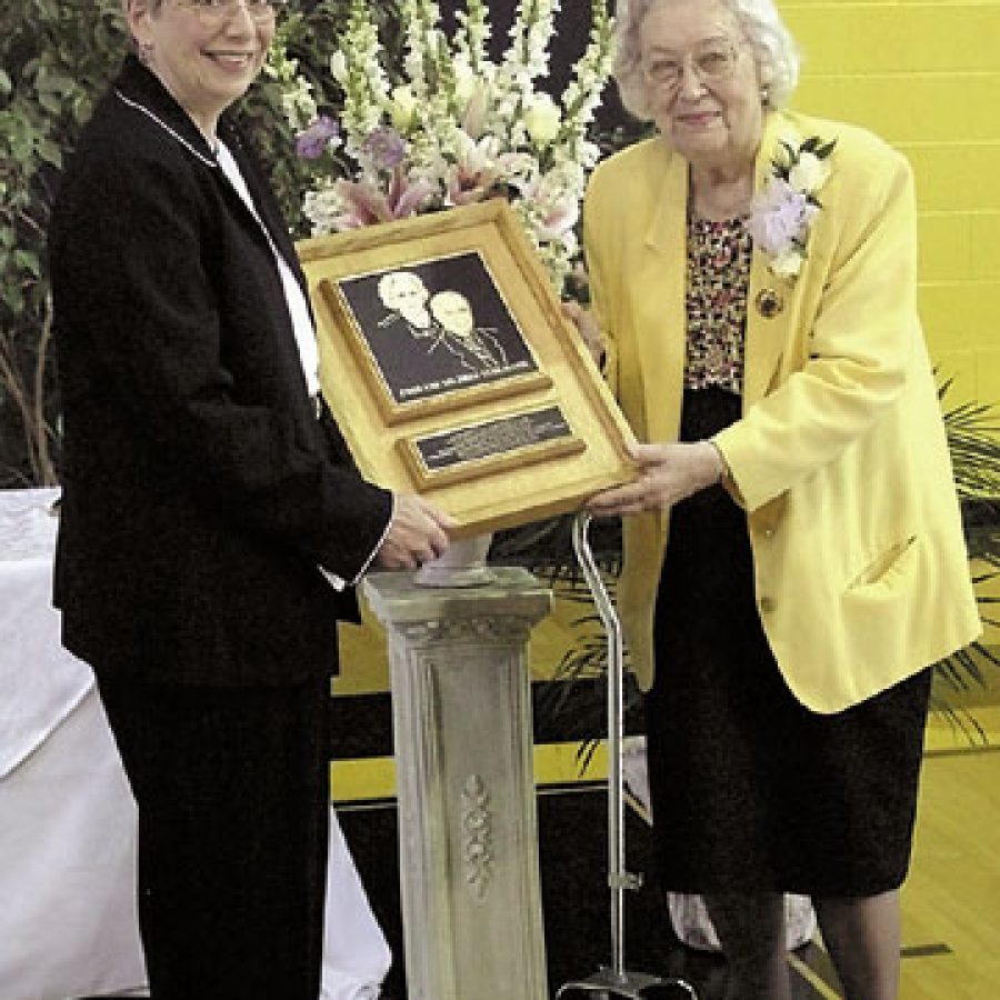 Lutheran High School Association President Judith Meyer, left, presents a plaque to Mildred Kuhlmann in recognition of the Kuhlmann familys support of Lutheran High School South.