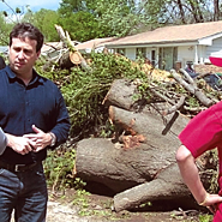 County Council Chairman Steve Stenger, third from left, speaks with Berkeley residents struggling to pick up the pieces after the devastating April 22 tornado.