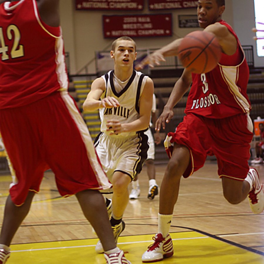 Oakville Senior Highs Gary Evans threads a pass between Homewood-Flossmoors Michael Rouse and Tim Williams in the Tigers loss to the Vikings. Stephen Glover photo