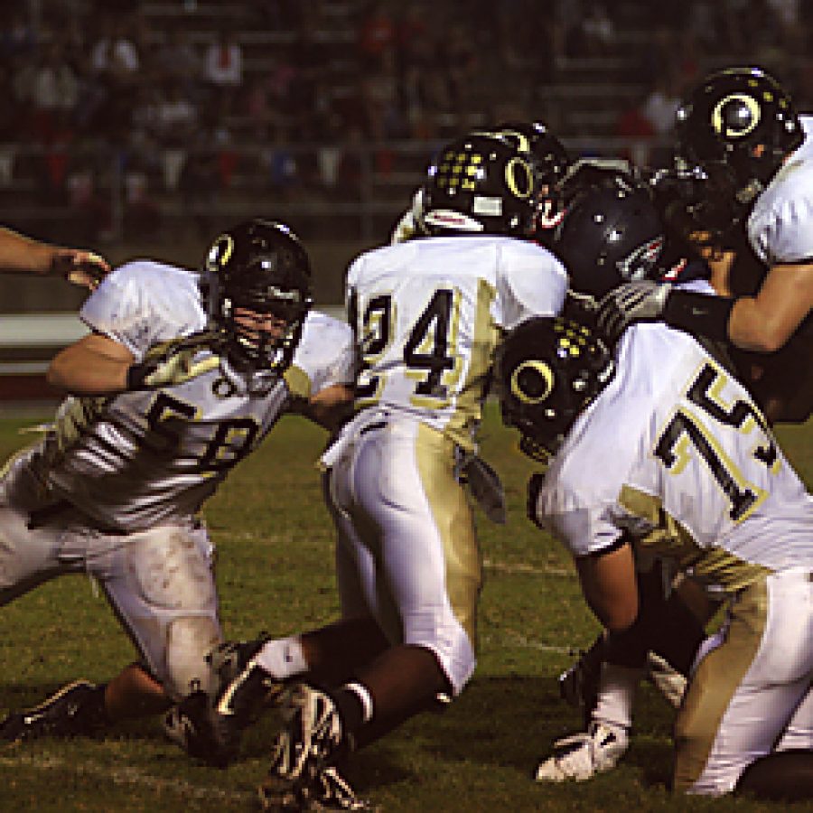 Stephen Glover photo
Oakville Senior High Schools Lavelle Boyd, Kody Kolb and Eric Simon take down Parkway South running back Lawrence Scott in the Tigers 28-13 win over the Patriots Friday night. Stephen Glover photo