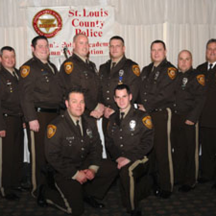 Dan Schroeder of the 4th Precinct was honored as the 2011 Officer of the Year.  Nominees with their commanders and chief, standing, from left, are: Lt. Ken Cox, Capt. Marion Monteleone, Jeffery Hoots, Kevin Helldoefer, Schroeder, John Wilson, Mike Schira, Chuck Weinman, Chief Tim Fitch, Capt. Mike Dierkes and Lt. Col. Terry Roberds. Kneeling, from left, are: Aaron Roediger and Joseph Patterson.
