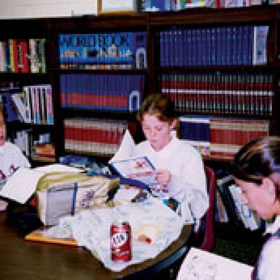 Queen of All Saints pupils Mimi Sinclair, Elizabeth Schuler and Emily Bahr share their favorite poetry during a recent meeting of the new PALS Club — Poetry at Lunchtime Sharing.