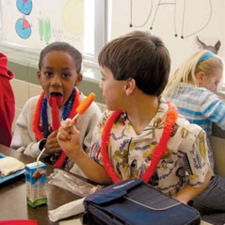 Looking for a little tast of summer, third-grade pupils, below, from left, Darrion Strong and Jordan DeMars enjoy their popsicles at lunch during Trautwein Accelerated Schools Freezing Fun in February.