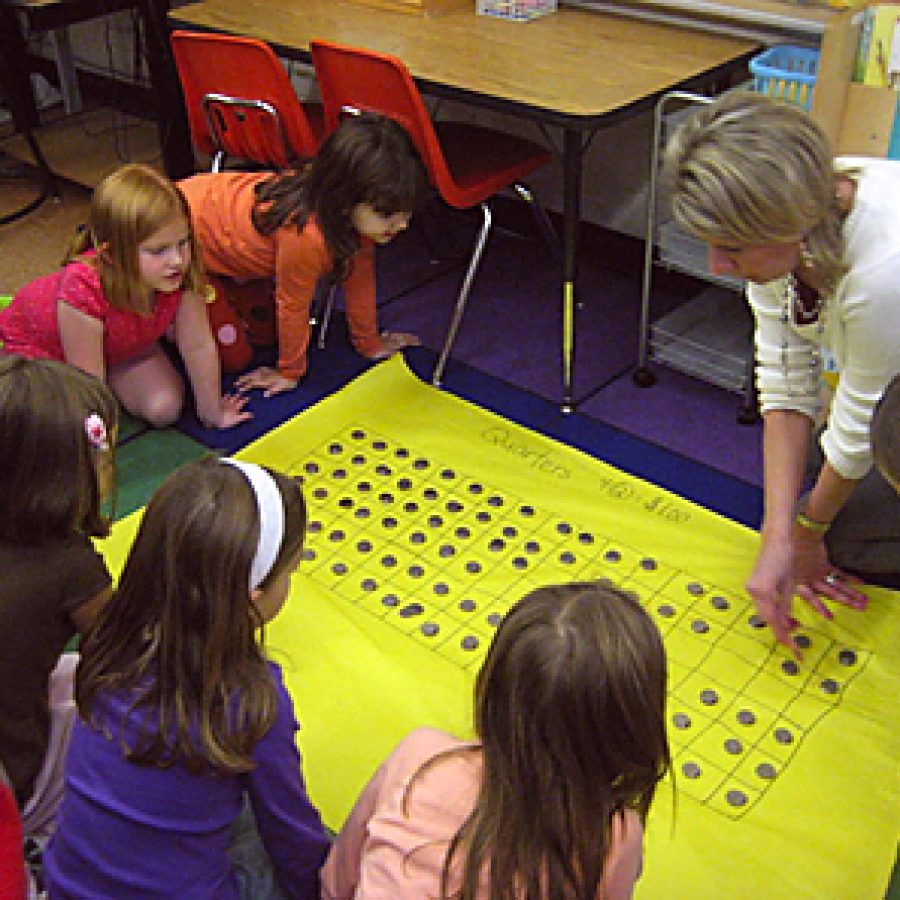 Pupils in Jennifer Koenigs first-grade class at Point Elementary School turned their fundraiser into a learning opportunity by separating and counting all the money they collected. 