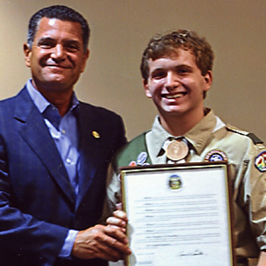 State Sen. Jim Lembke presents a Senate resolution to Eagle Scout Alex Reitz during his Eagle Court of Honor ceremony.