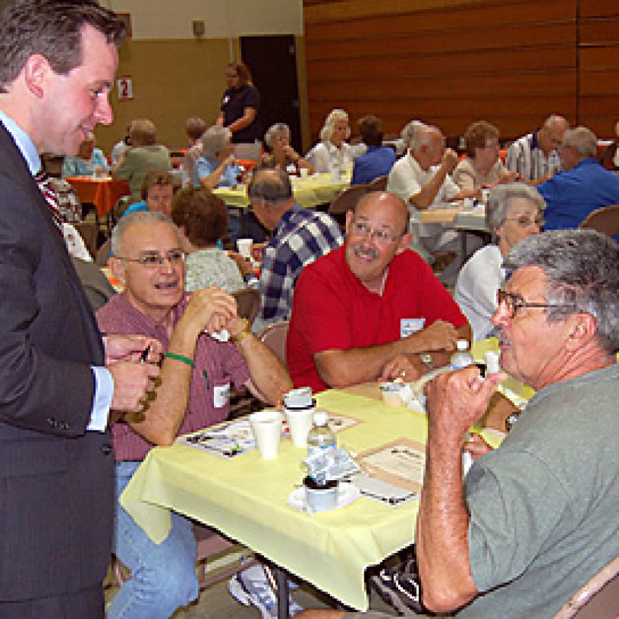 Washington Middle School Assistant Principal Patrick Keenoy visits with guests at the Mehlville School Districts 60-Plus Autumn Social at the middle school.