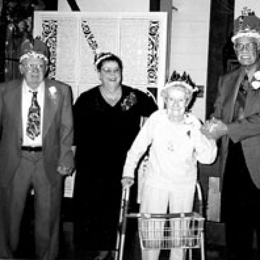At the Senior Prom fund-raiser, from left, Sweetheart King and Queen Bob and Patsy Houseman crown Prom King Walter Bradford and Prom Queen Hilda Lammert.
