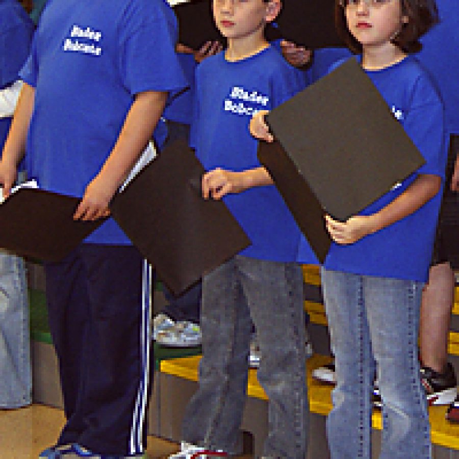 Pupils in the Blades Character Choir, an extracurricular group at Blades Elementary School that meets before school with the mission of using its performance talents as a service to others, will use their musical skills to entertain troops overseas this holiday season. Above, Blades Character Choir members Max Franey, Devin Roth and Chloe Armistead prepare to record a holiday CD for the troops.