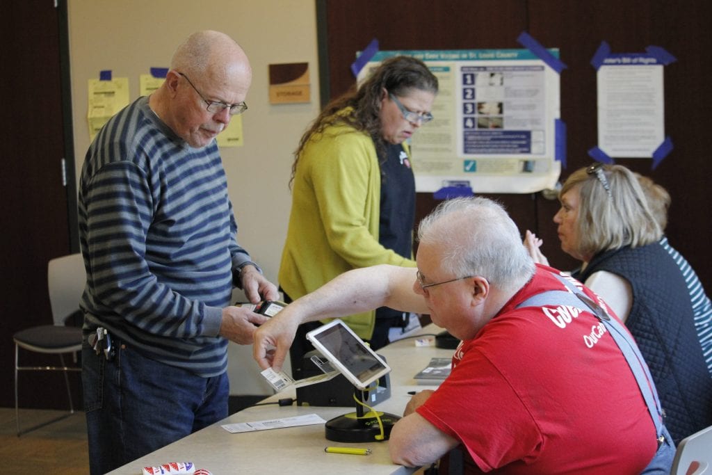 Voters check in to cast their ballots at the Sunset Hills Community Center during the April 2019 election.