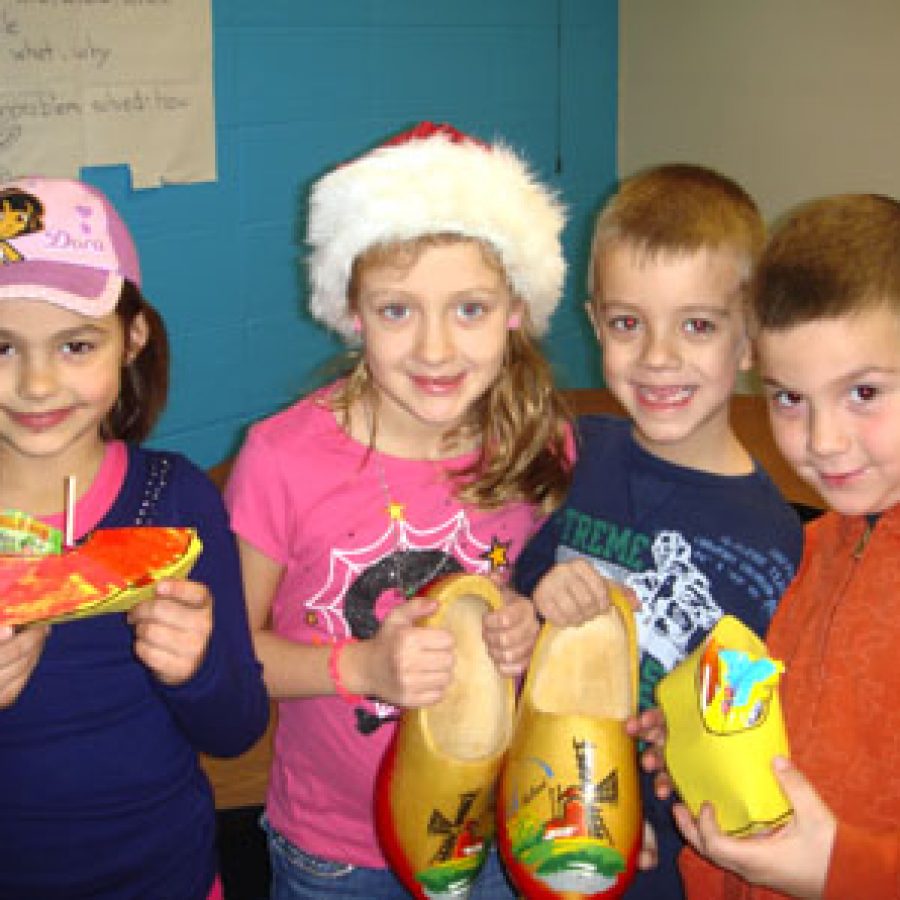 Sappington Elementary School first-graders display wooden shoes they made to learn about St. Nikolaus Day, which traditionally is celebrated in Holland and Germany on Dec. 5.
