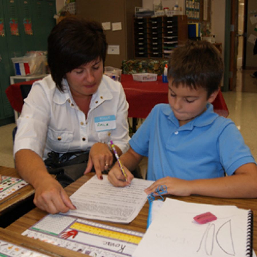 Forder Elementary second grader Ervin Kovac works on a class assignment with his mother, Amila, during the schools World Cafe Day held on Sept. 23. More than a dozen Forder English Language Learner students brought their parents to school with them for the event, which gave parents a glimpse into their childs daily routine and provided them with information about the resources available to ELL students and their families through the Mehlville School District.